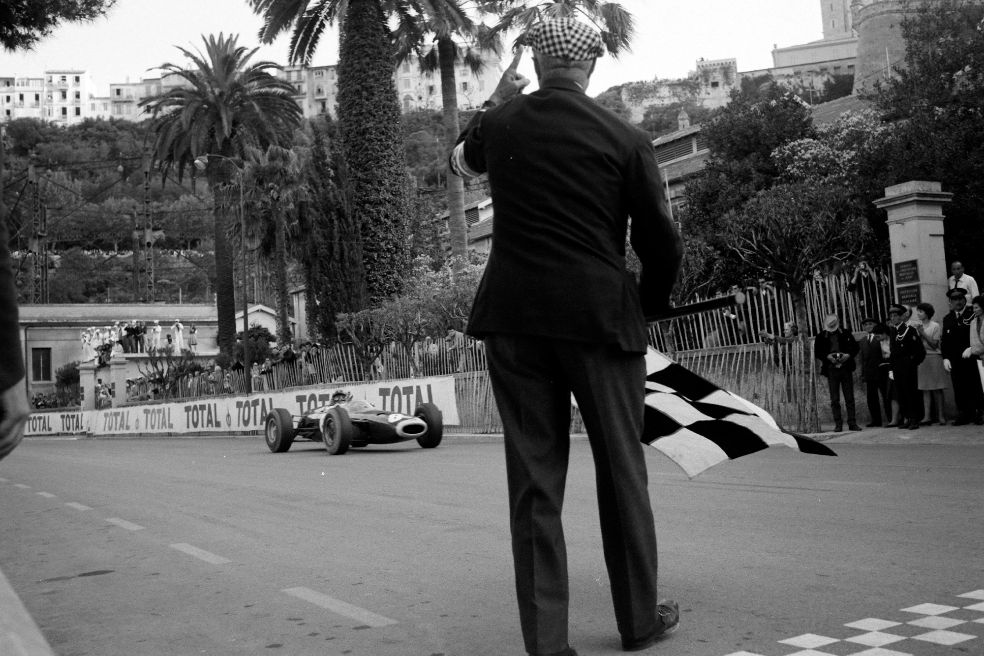 Graham Hill, BRM P261, takes the chequered flag and victory.