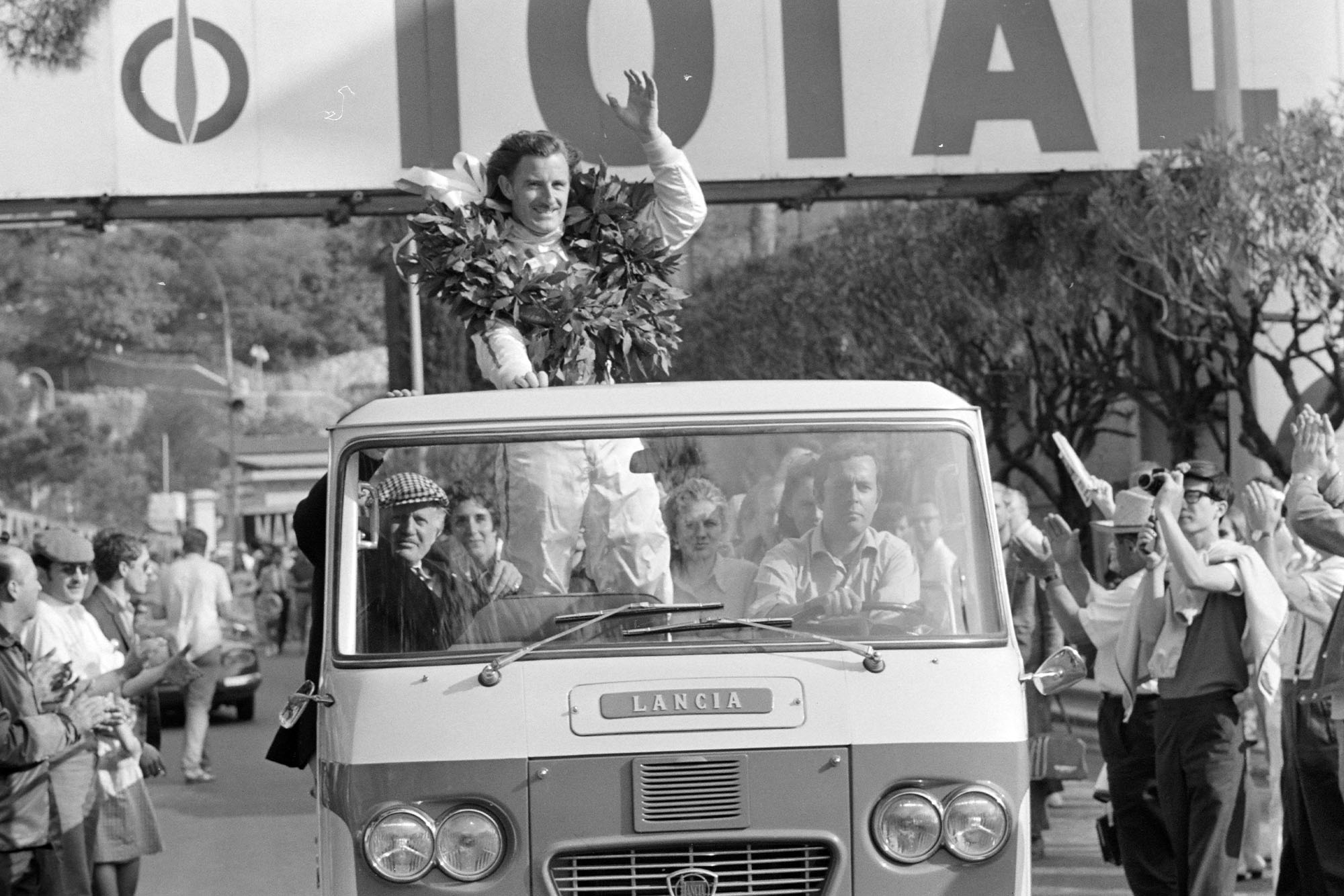 Graham Hill celebrates victory on the parade lap.