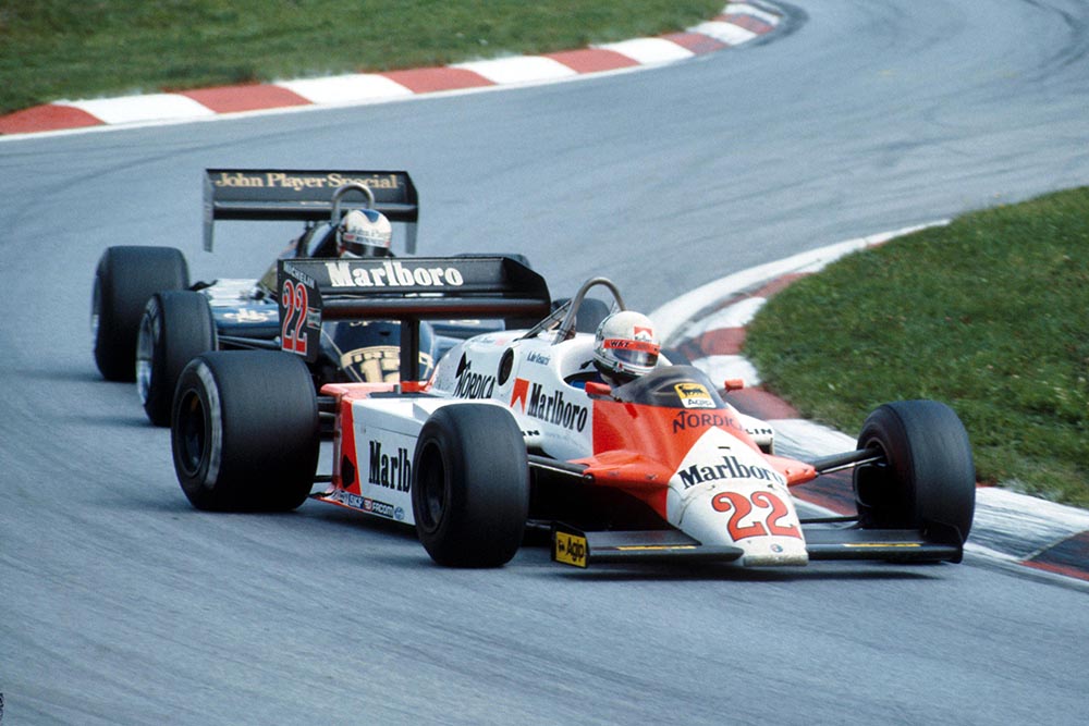 Andrea de Cesaris, Alfa Romeo, leads Nigel Mansell, Lotus.