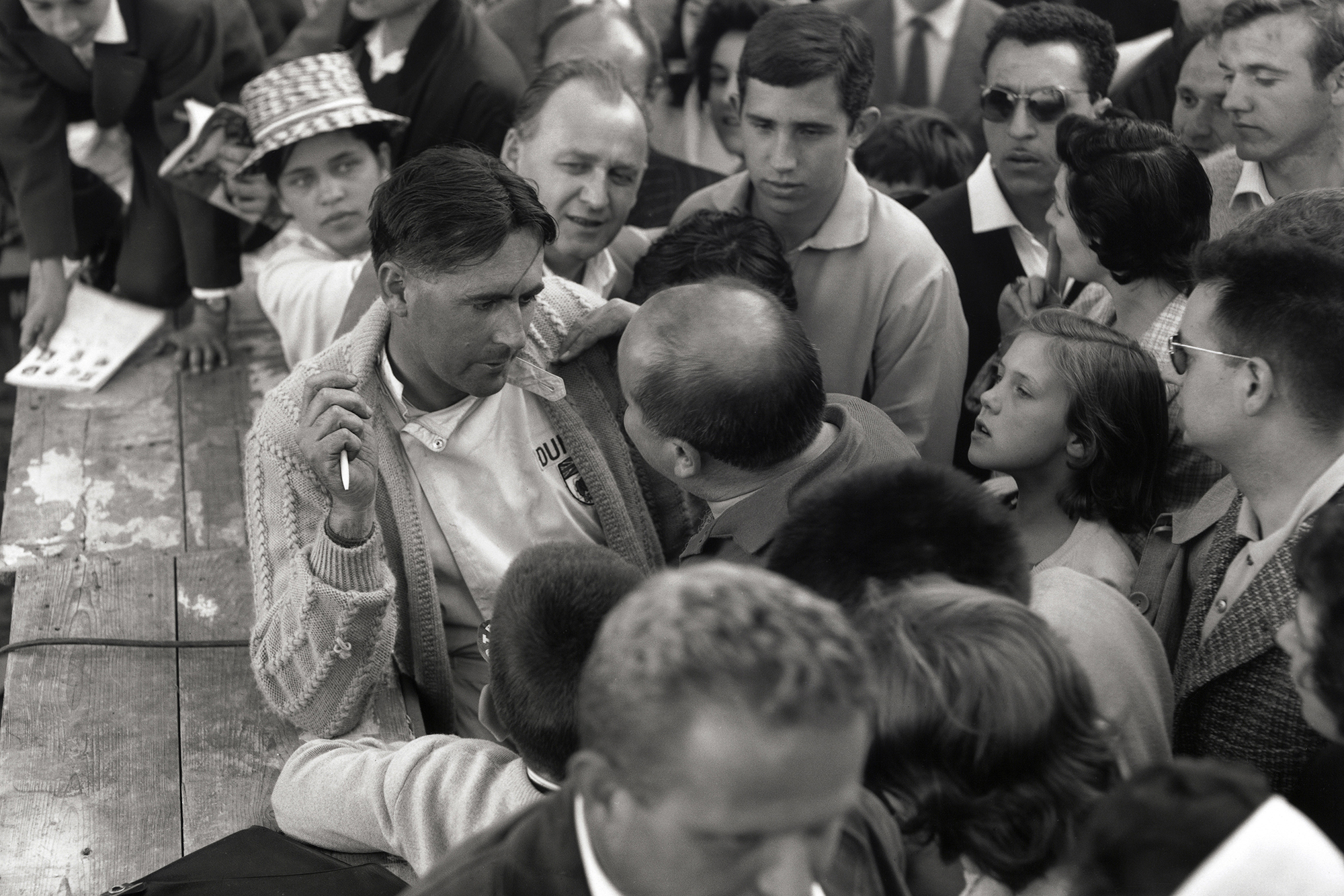 Jack Brabham talks with with a young autograph hunter.