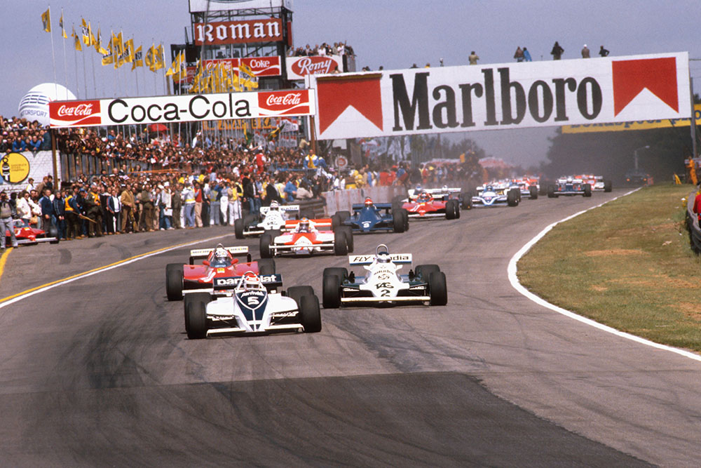Nelson Piquet (Brabham BT49C Ford) leads Carlos Reutemann (Williams FW07C Ford) and Didier Pironi (Ferrari 126CK) at the start.