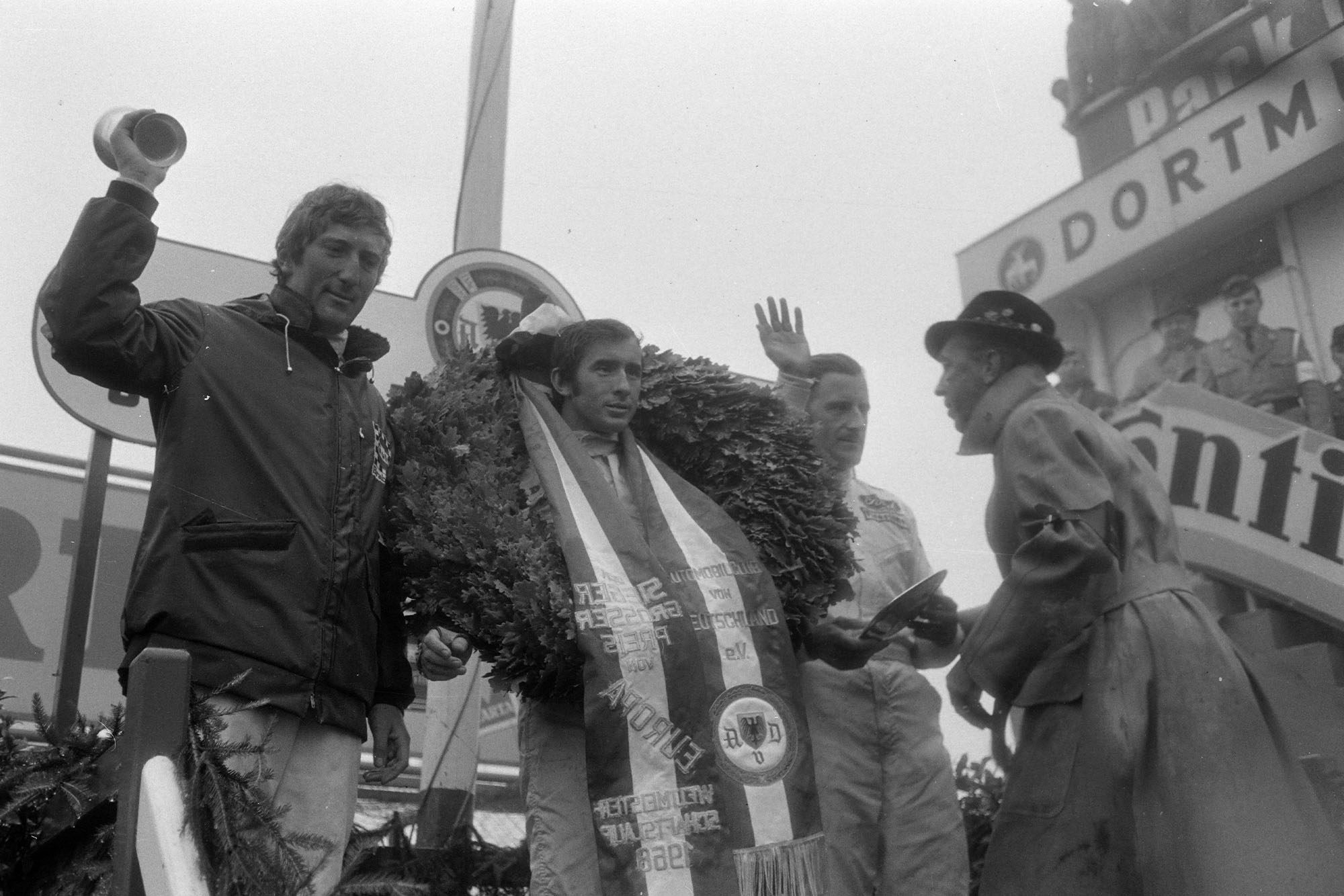 ackie Stewart, 1st position, celebrates victory on the podium with Graham Hill, 2nd position, and Jochen Rindt, 3rd position.