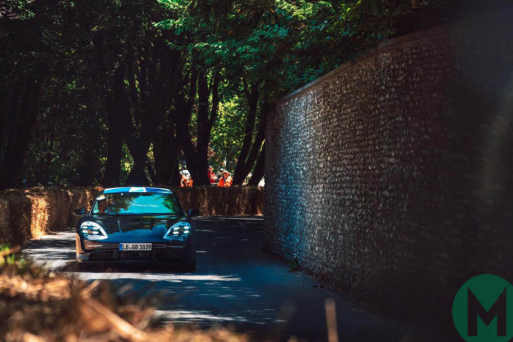 The electric Porsche Taycan races up the hill at the 2019 Goodwood Festival of Speed