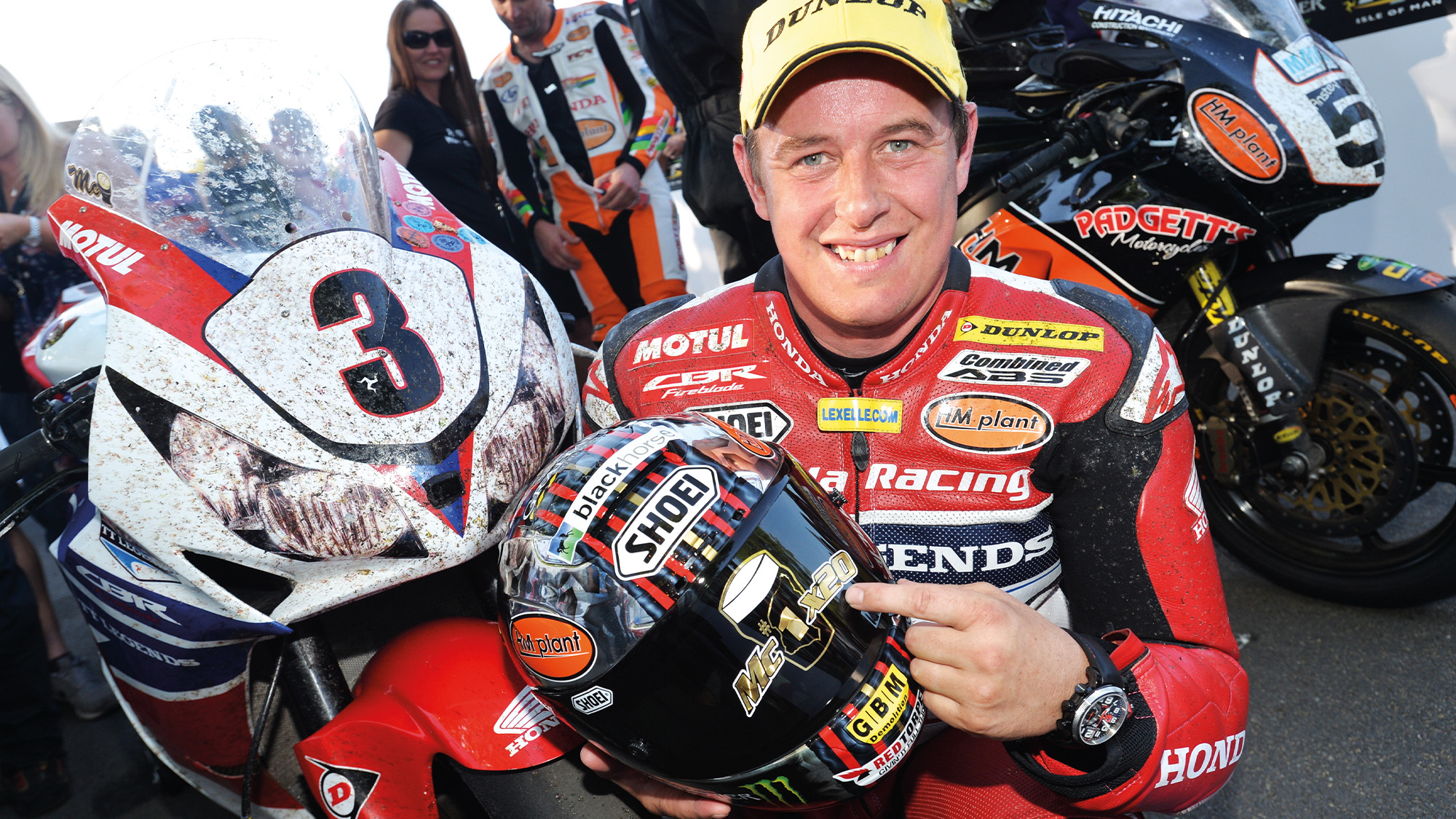 John McGuinness points to his helmet marking 20 Isle of Man TT wins