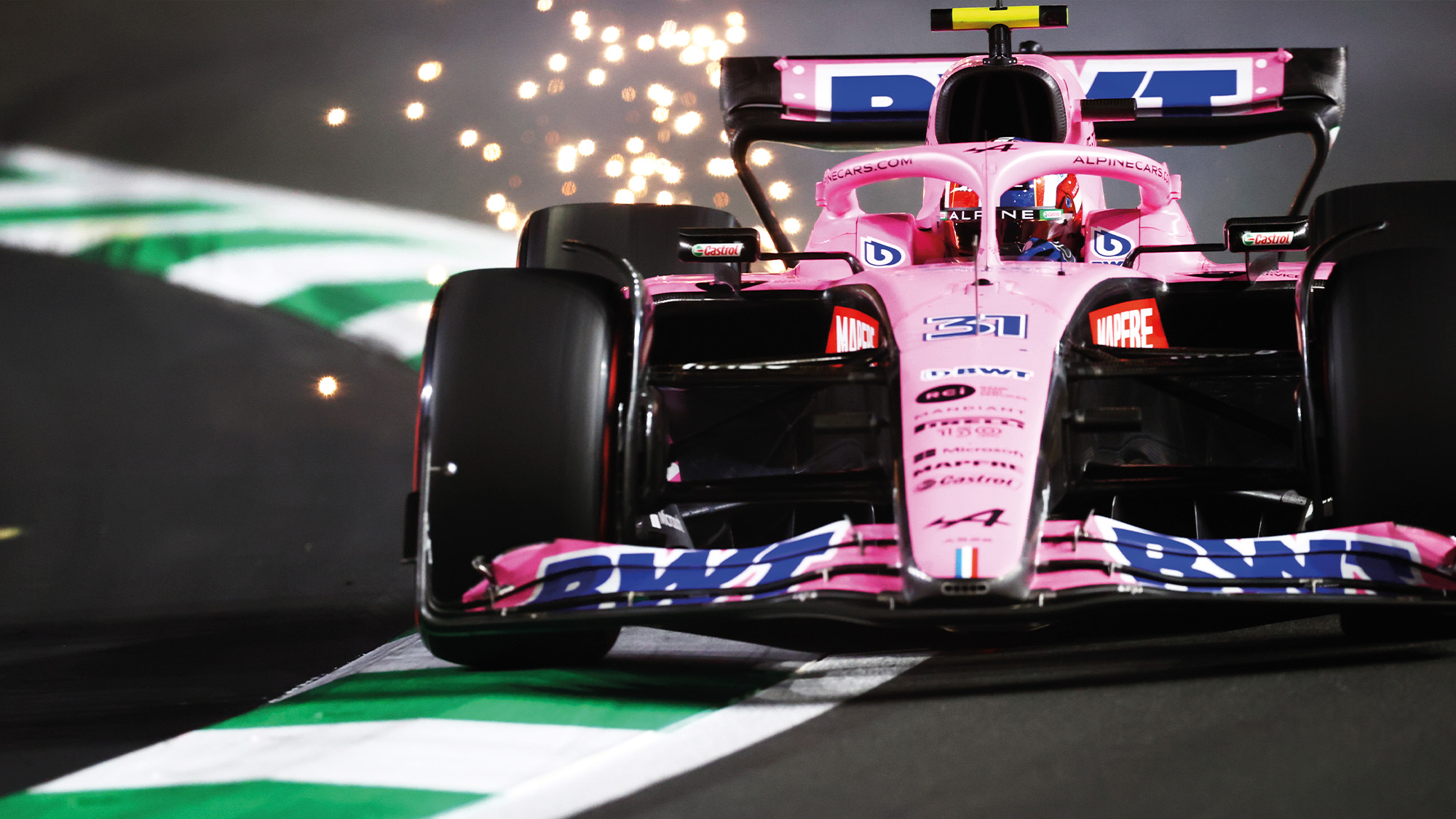 Sparks fly from the Alpine F1 car of Esteban Ocon